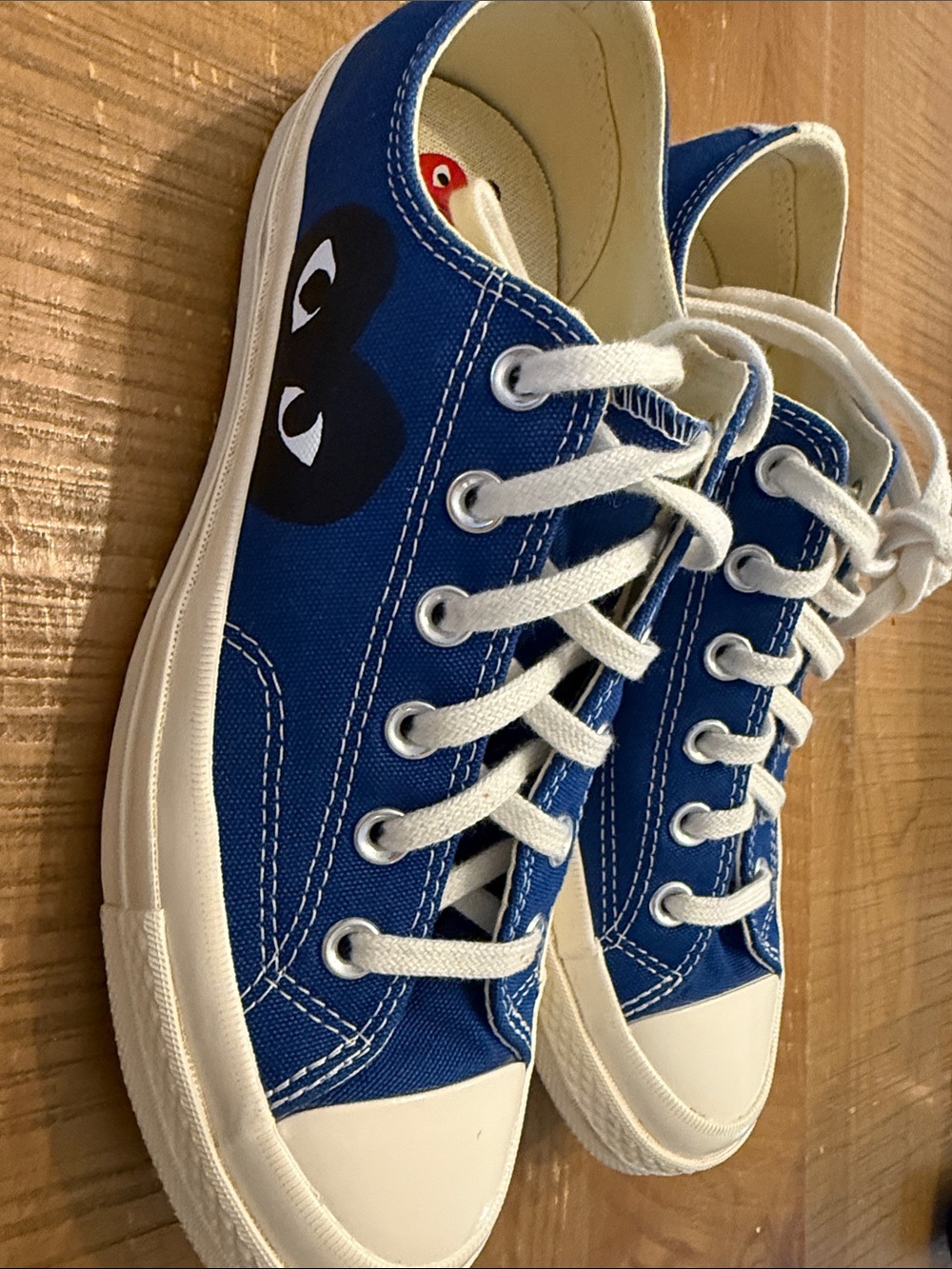 Converse blue canvas sneakers with white laces and black heart logo
